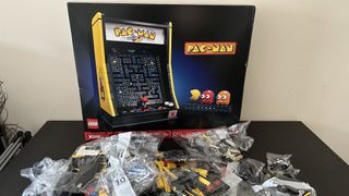 Lego Pac-Man Arcade box with bags of bricks on a black table