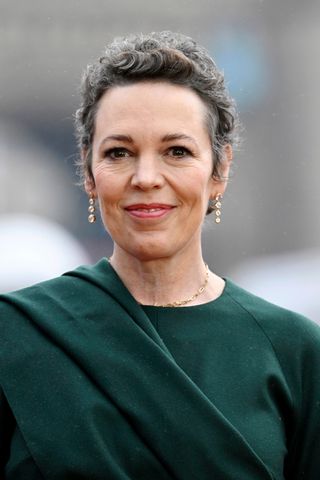 Olivia Colman is pictured with grey hair whilst arriving at the "Wonka" Photocall at Potters Field on November 27, 2023 in London, England.