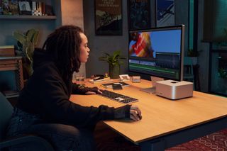 A video editor using a Mac Studio and Studio Display.