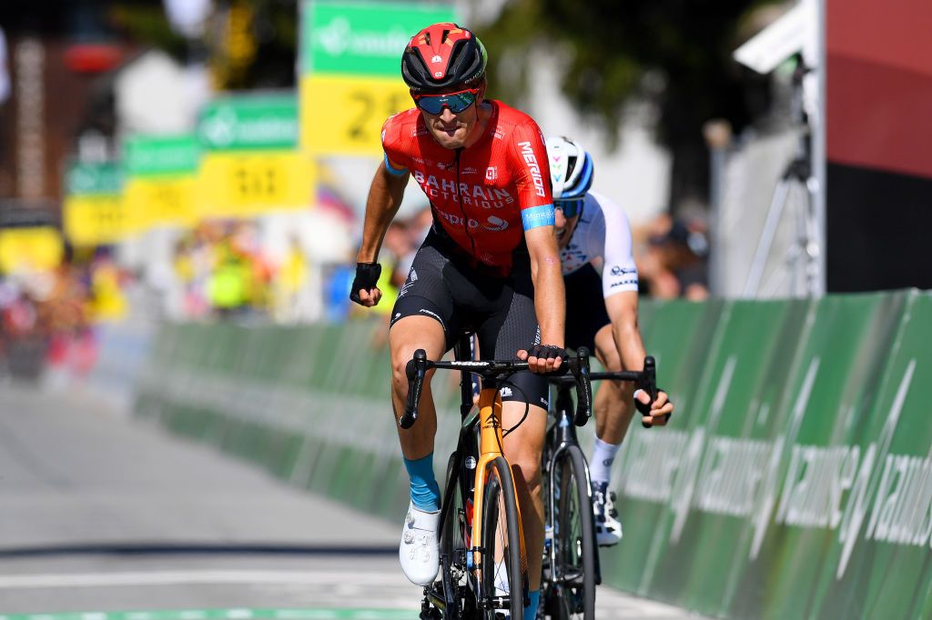 ANDERMATT SWITZERLAND JUNE 13 Gino Mder of Switzerland and Team Bahrain Victorious stage winner celebrates at arrival Michael Woods of Canada and Team Israel StartUp Nation during the 84th Tour de Suisse 2021 Stage 8 a 1595km stage from Andermatt to Andermatt UCIworldtour tds tourdesuisse on June 13 2021 in Andermatt Switzerland Photo by Tim de WaeleGetty Images