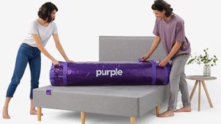 A coupled unpack a Purple mattress on a grey bed base