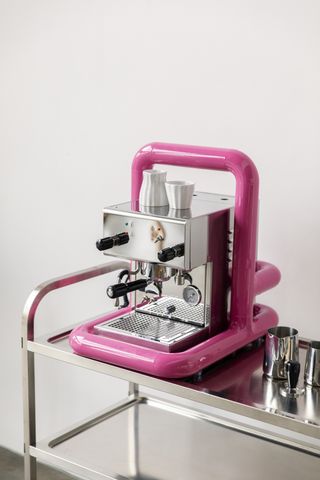 pink frame for modern coffee machine on stainless steel countertop