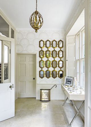 hexagonal mirrors in an entrance hall with white tiled floor