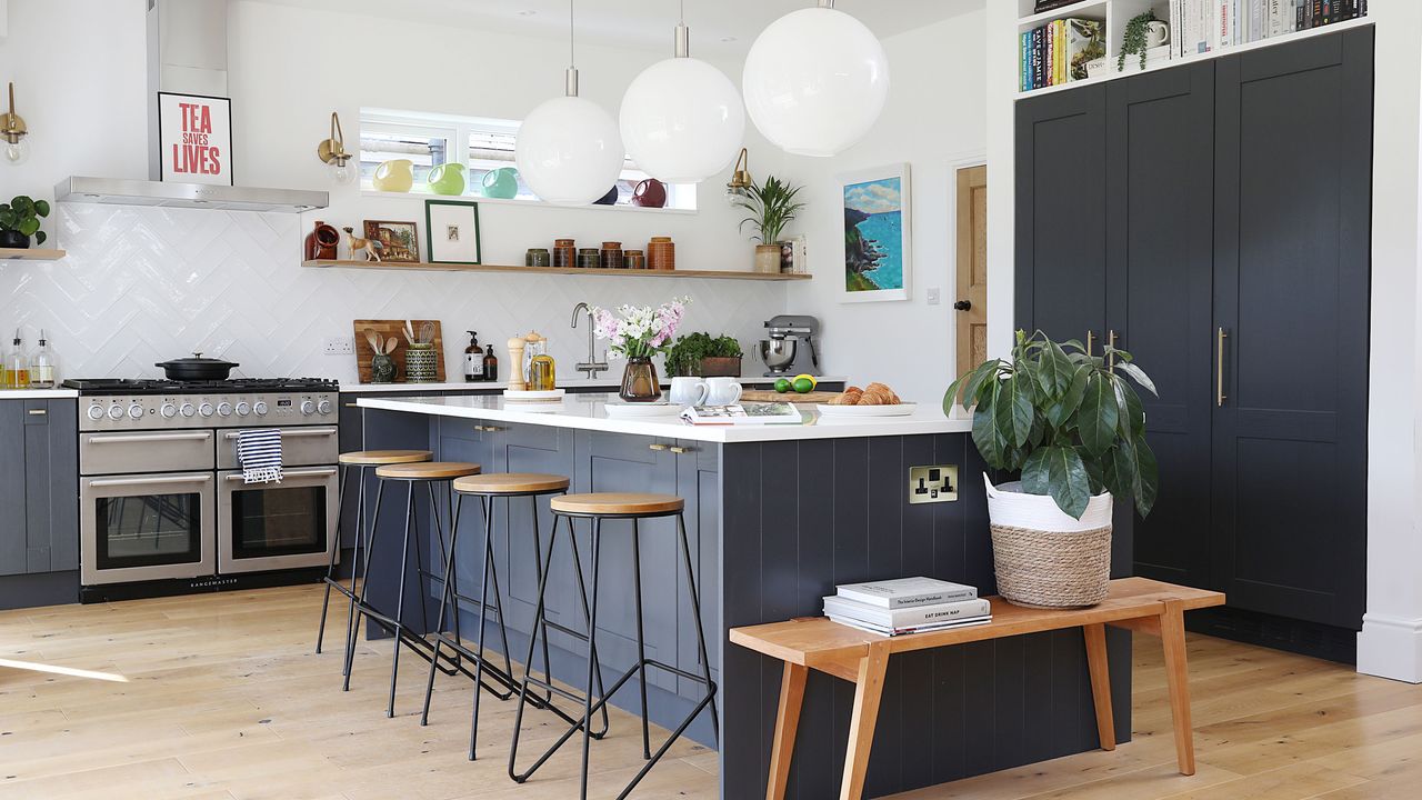 Blue kitchen with island and wooden bench seat