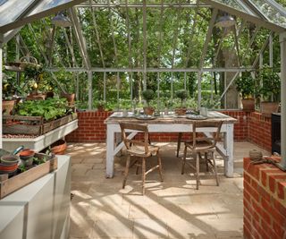 tumbled limestone floor in a glass outbuilding potting garden room