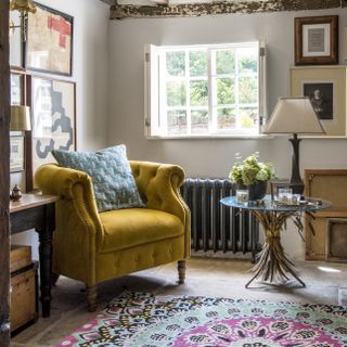 living room with yellow arm chair and blue cushion