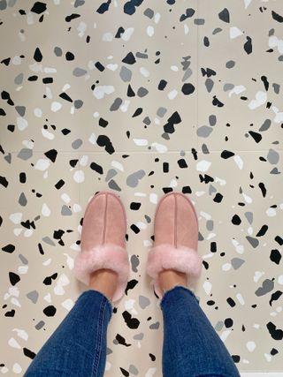 Beige bathroom tiles with terrazzo stencil in white and black pattern