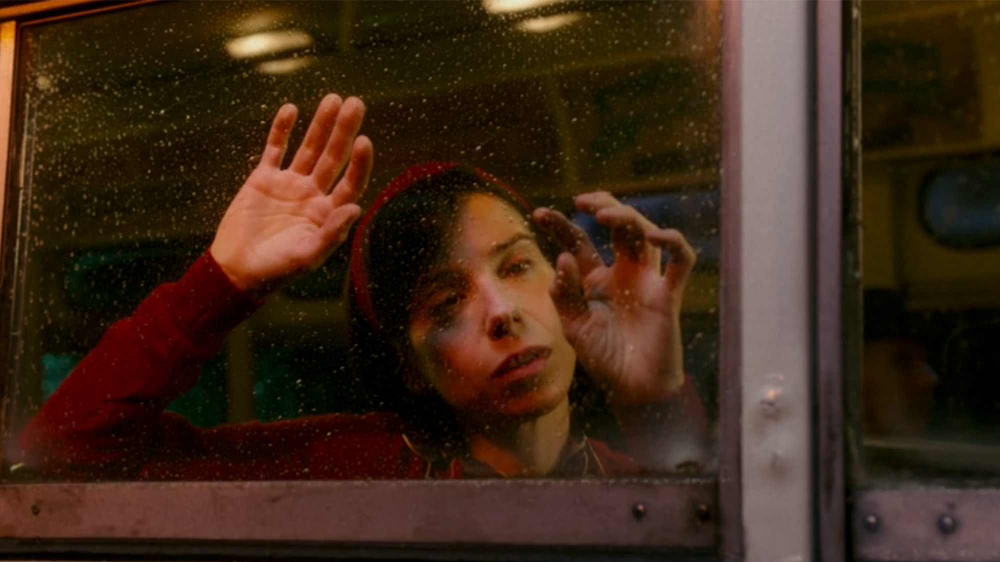 A woman pressing her hands against a window in The Shape of Water
