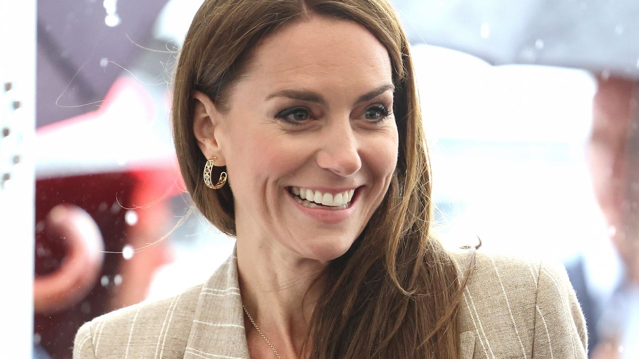 Kate Middleton braves the rain in chic pinstripe blazer