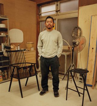 Kodai Iwamoto, photographed by Den Niwa, at his maker space in Tokyo, with his ‘Possum’ chair and ‘Bent’ stool. Photography: Tomohiko Ogihara