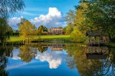 A 12ft-wide concrete rill was removed and overgrown leylandii cleared to reveal the main view to the 1810 manor house. The Gardens at Priors Marston, Warwickshire. Photograph: Clive Nichols