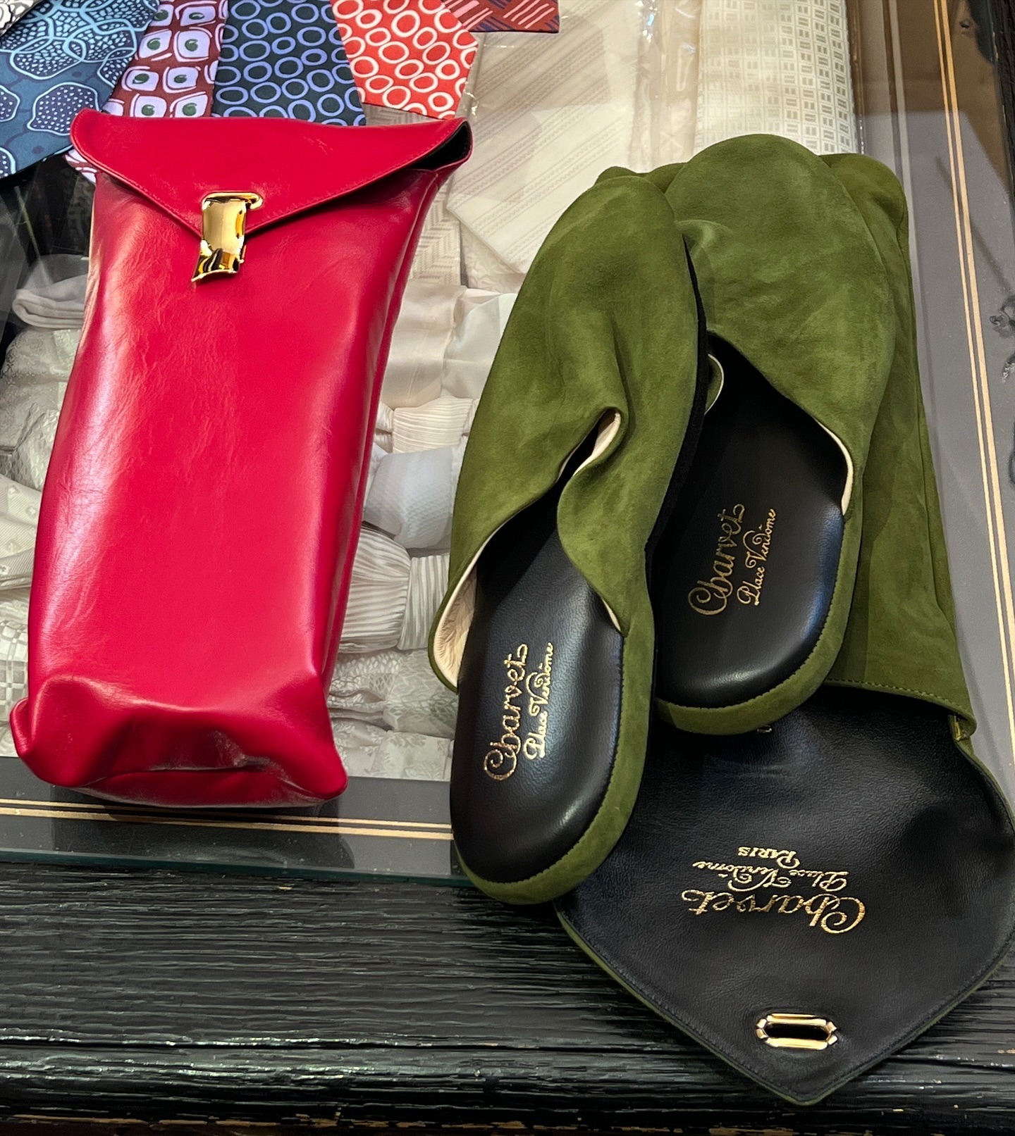 A counter at Charvet in Paris with a red and a green pair on the counter.