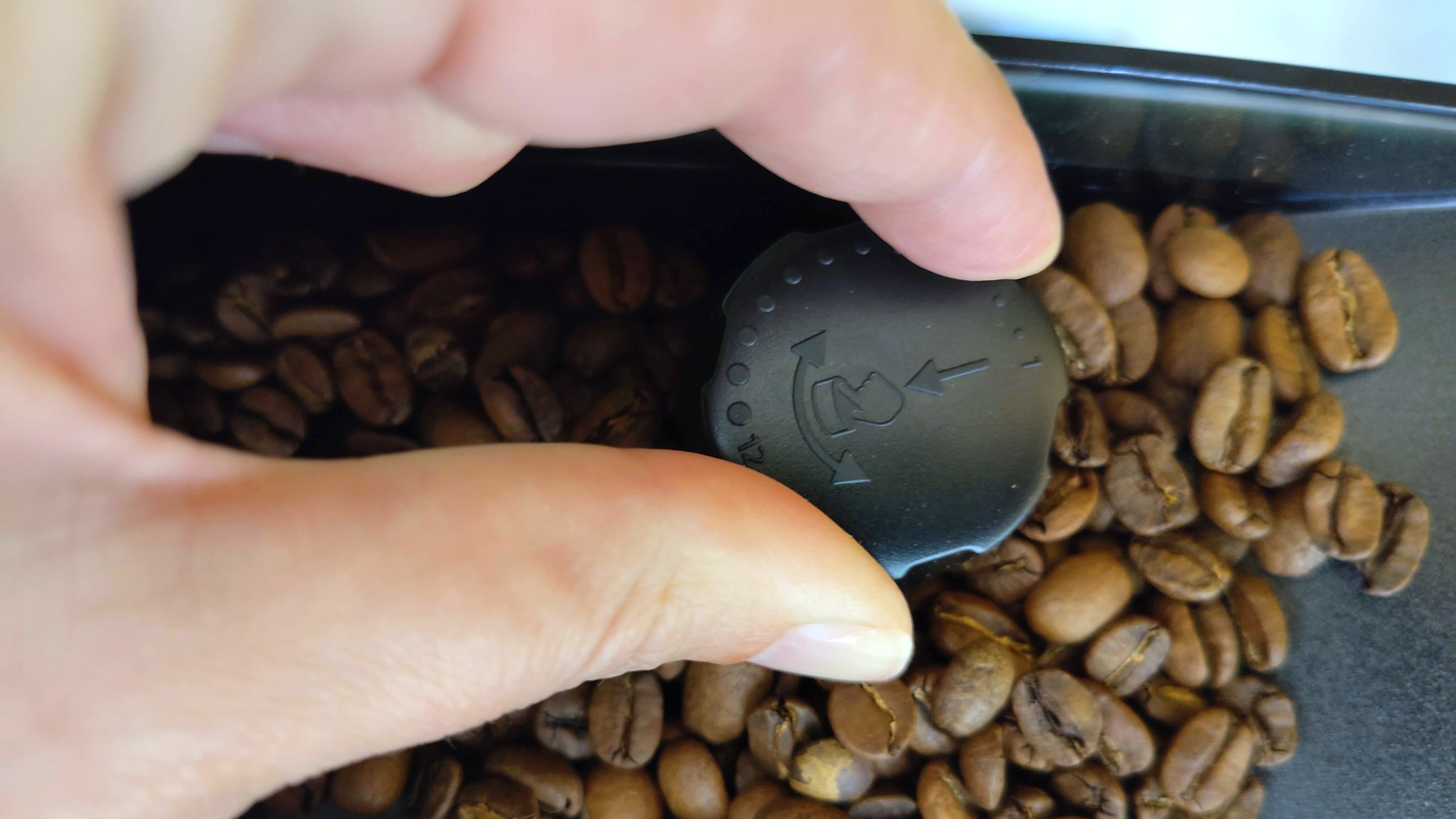 Person's hand adjusting Philips LatteGo 5500 Series grinder