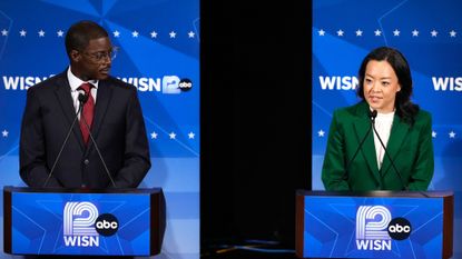Democratic gubernatorial candidate Francesca Hong, right, talks as David Crowley listens during a primary debate in Milwaukee.