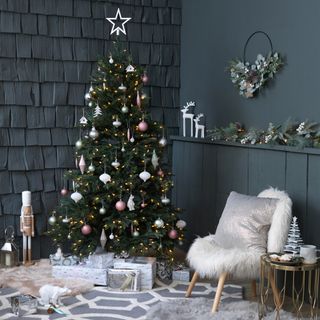 Dark blue living room with green Christmas with white and pastel decorations
