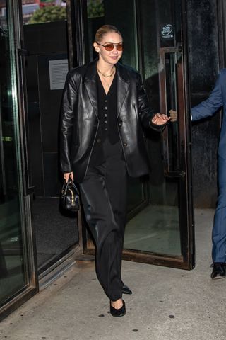 Gigi Hadid wears an all-black suit outfit in New York City.
