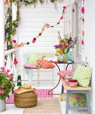 outside space with rugs cushions and paper flower garlands