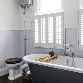 white traditional bathroom with wooden flooring