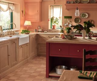 A pink and red kitchen with a large kitchen island