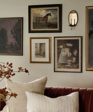 Close up of living room gallery wall, vintage frames and mirror/candle sconce