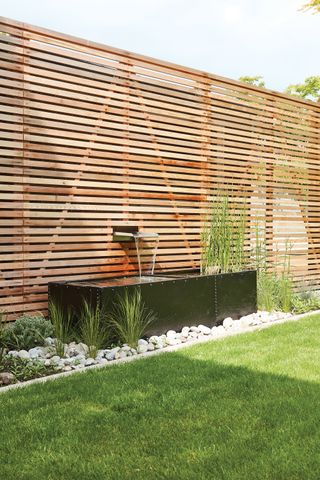 Modern horizontal garden fence with integrated water fountain