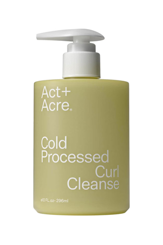 A bottle of Act+Acre cold processed curl cleanse set against a white background.