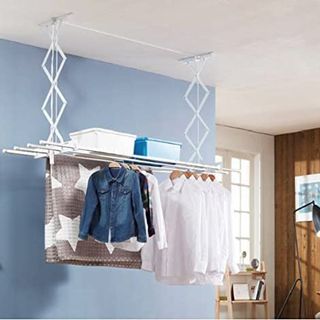 White clothes rack hanging from ceiling in blue room