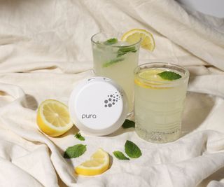 Pura air freshener on top of a blanket by lemon slice