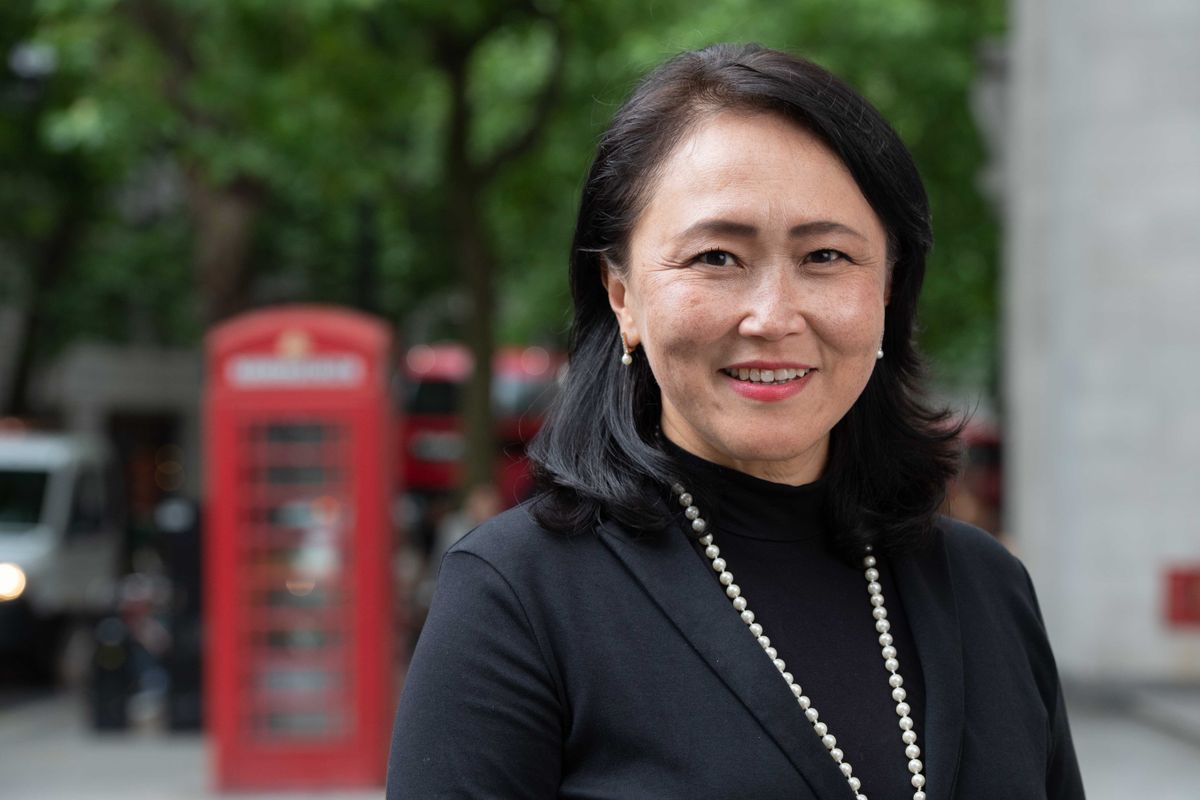 Professor Dana Minbaeva stood in front of a red London phone box