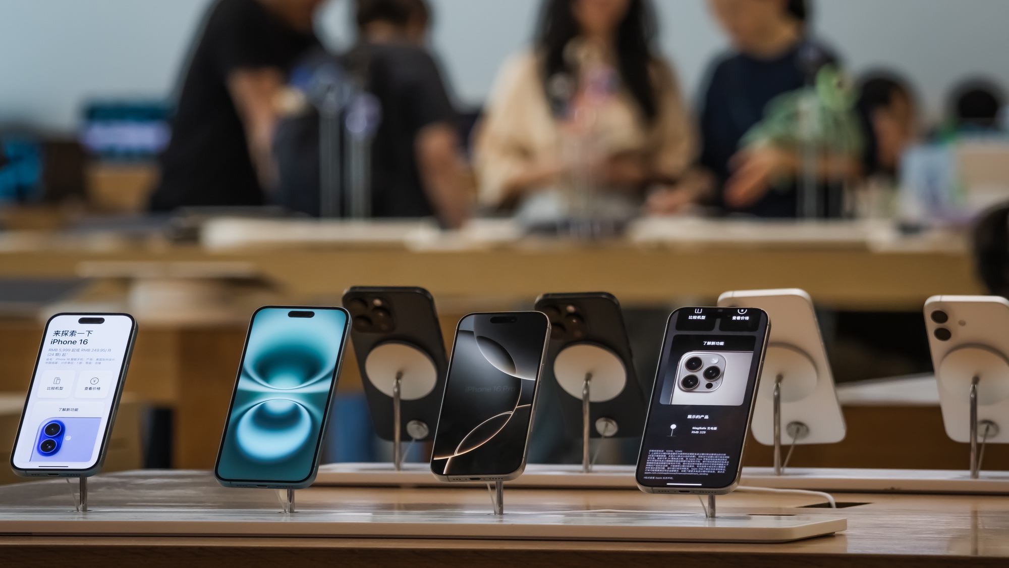Iphone 16 models on display at an Apple Store