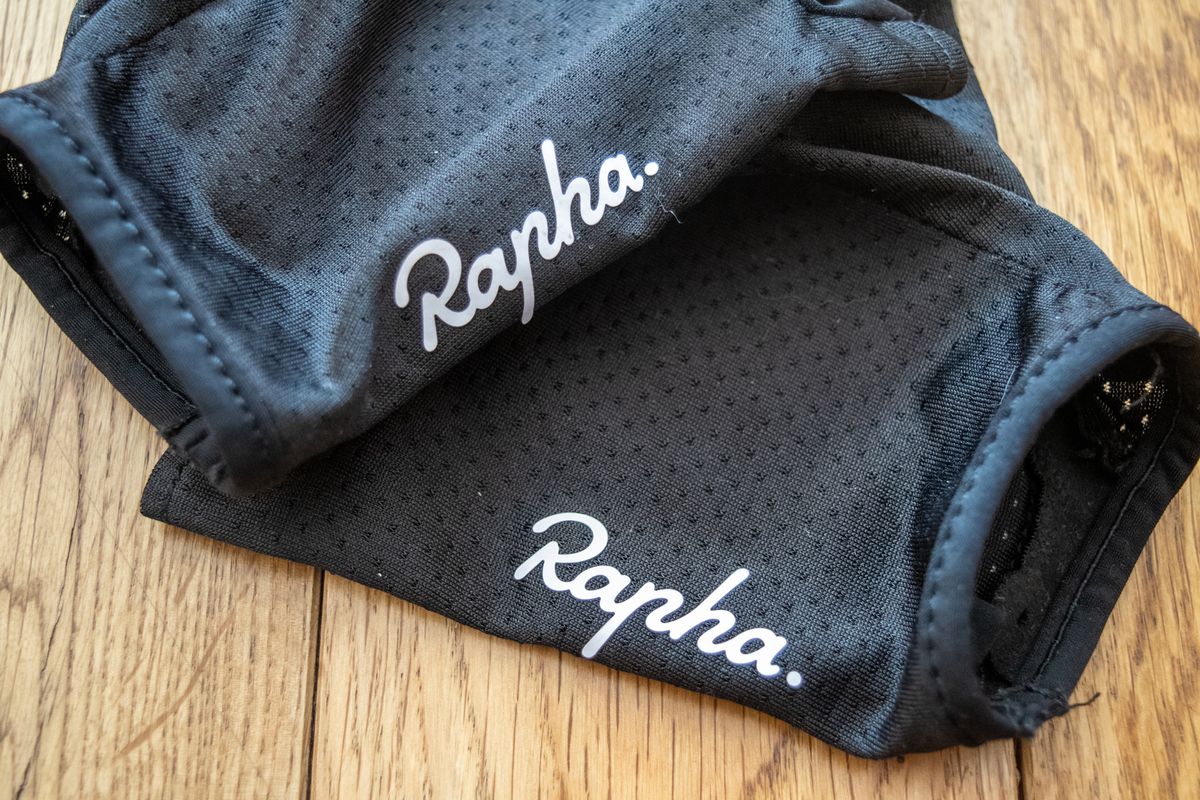 A black Rapha Core cycling mitt on a wooden floor 