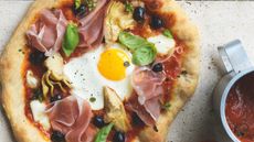 Artichoke, olive and parma ham pizza with an egg on top