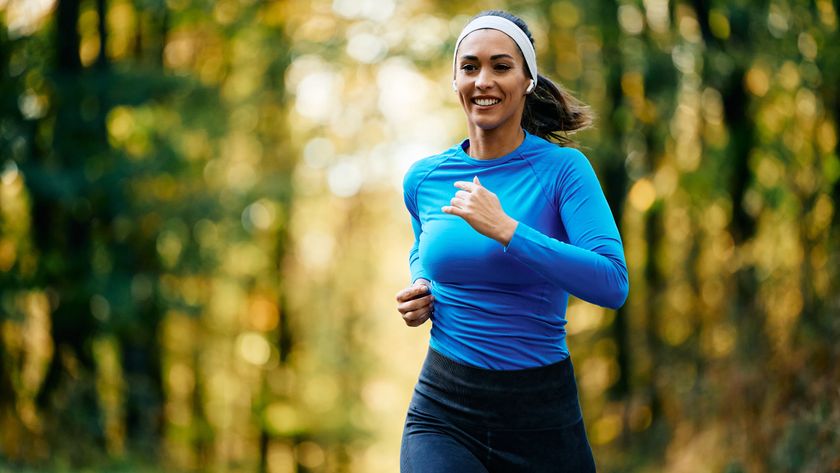 a woman running through a forest