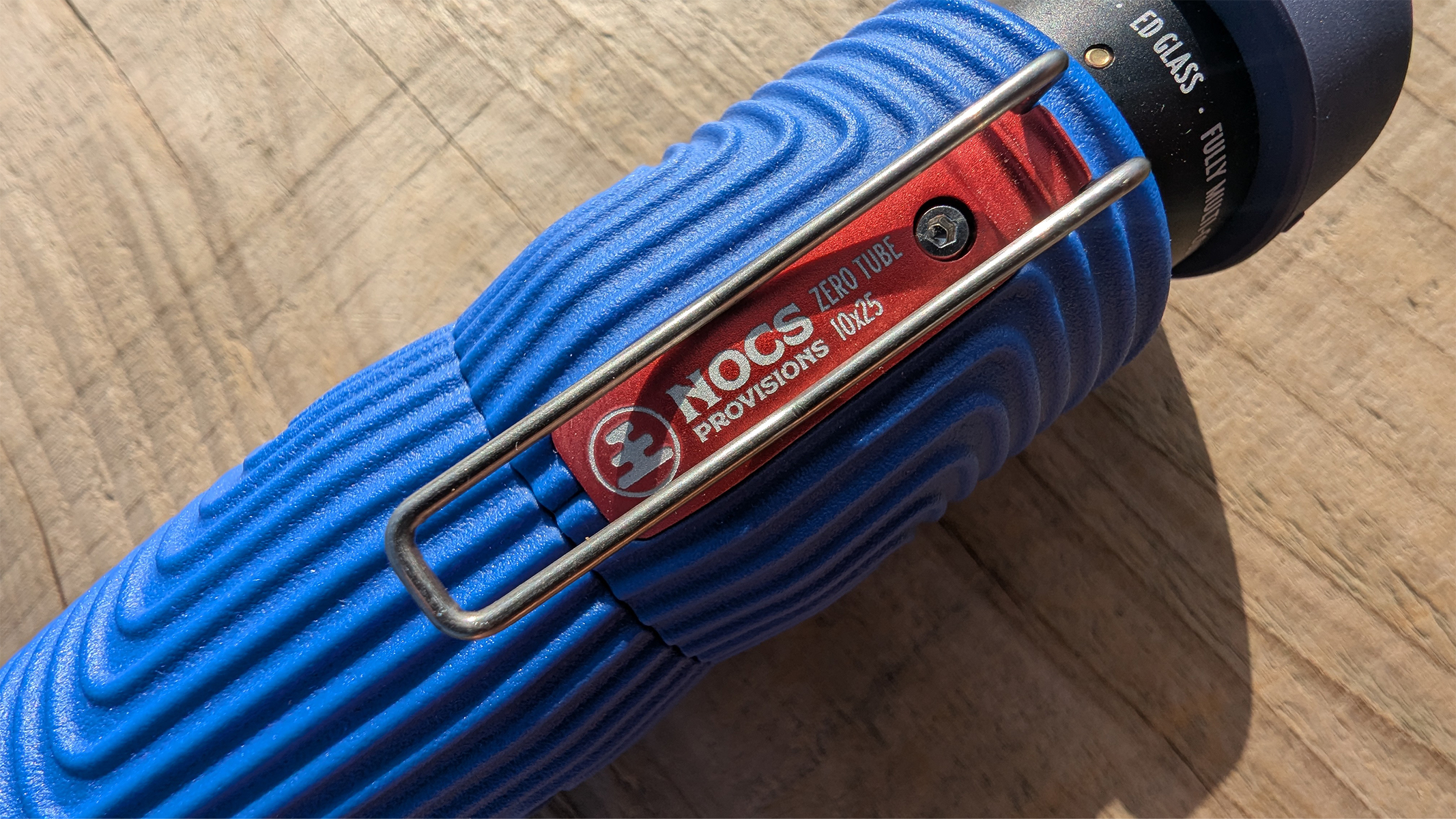 Nocs Zero Tube during review in the sunshine on a wooden table.