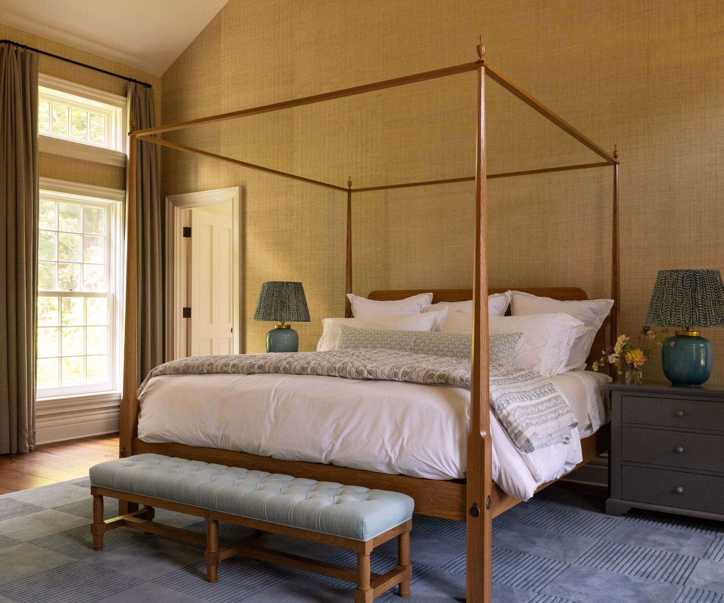 Yellow bedroom with blue carpet, four poster bed and blue bed