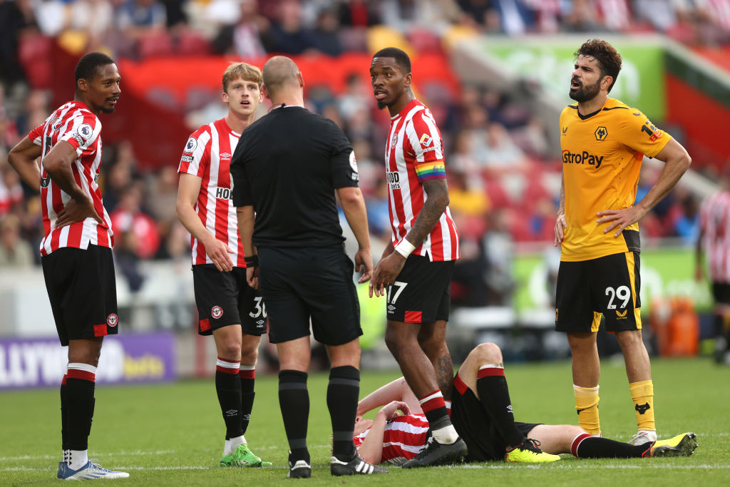 Referee Robert Madley speaks with Diego Costa of Wolverhampton Wanderers, before Diego Costa is shown a red card following a VAR Review, during the Premier League match between Brentford FC and Wolverhampton Wanderers at Brentford Community Stadium on October 29, 2022 in Brentford, England.