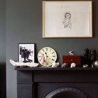 room with photoframe on grey wall and wall clock