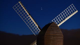 Jupiter and Saturn come together in the night sky, over the sails of Brill windmill, for what is known as the great conjunction, seen here on Dec. 20, 2020.