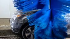 A car goes through a car wash.