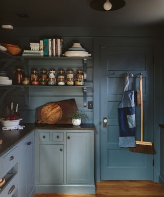 dark kitchen painted in dark blue paint, cozy decor