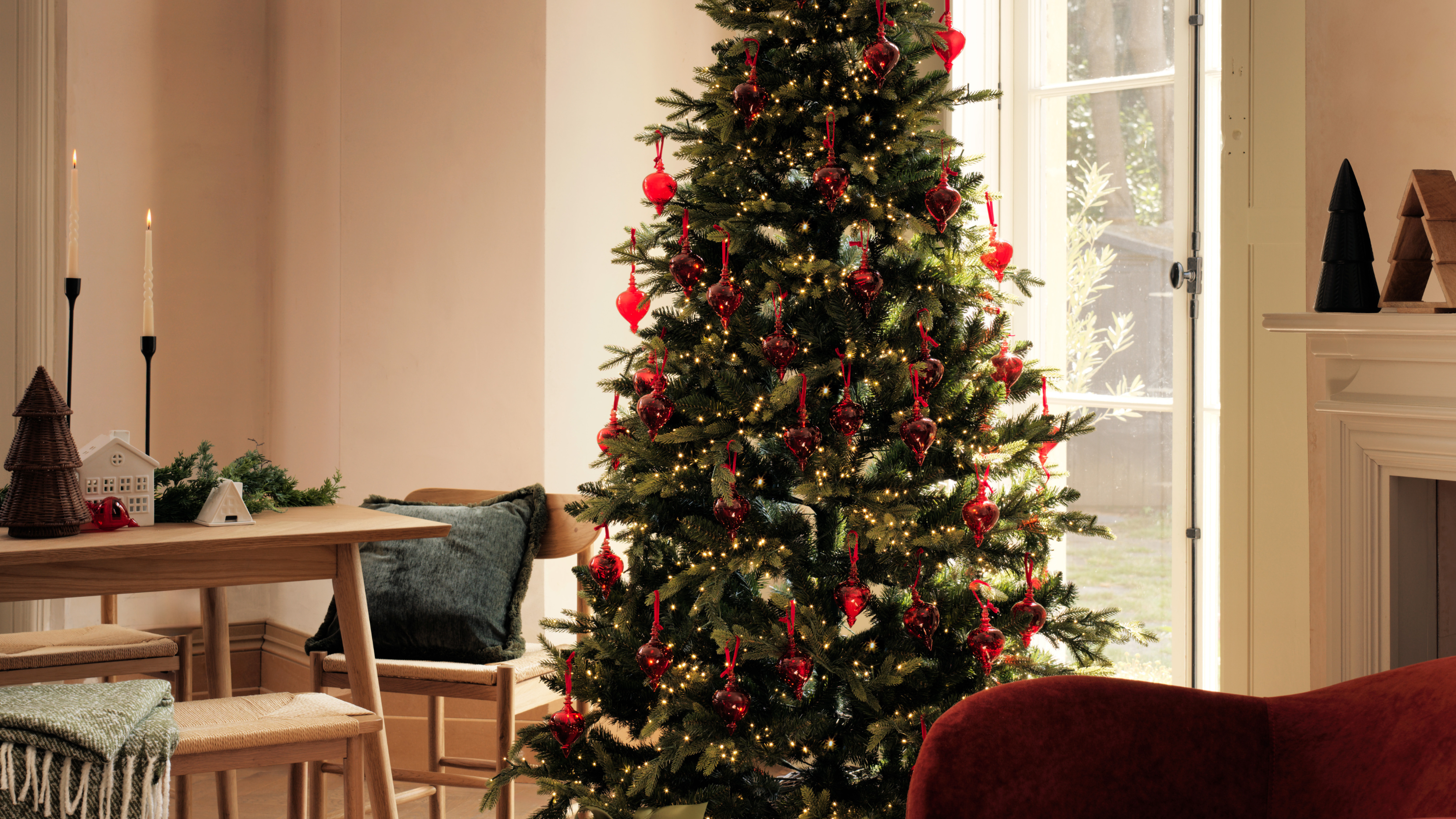 Christmas tree with soft gold lights and bright pink baubles.