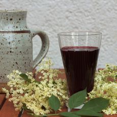 elderberry juice on table with flowers