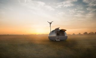 Single ecocapsule on grassy field at sunset