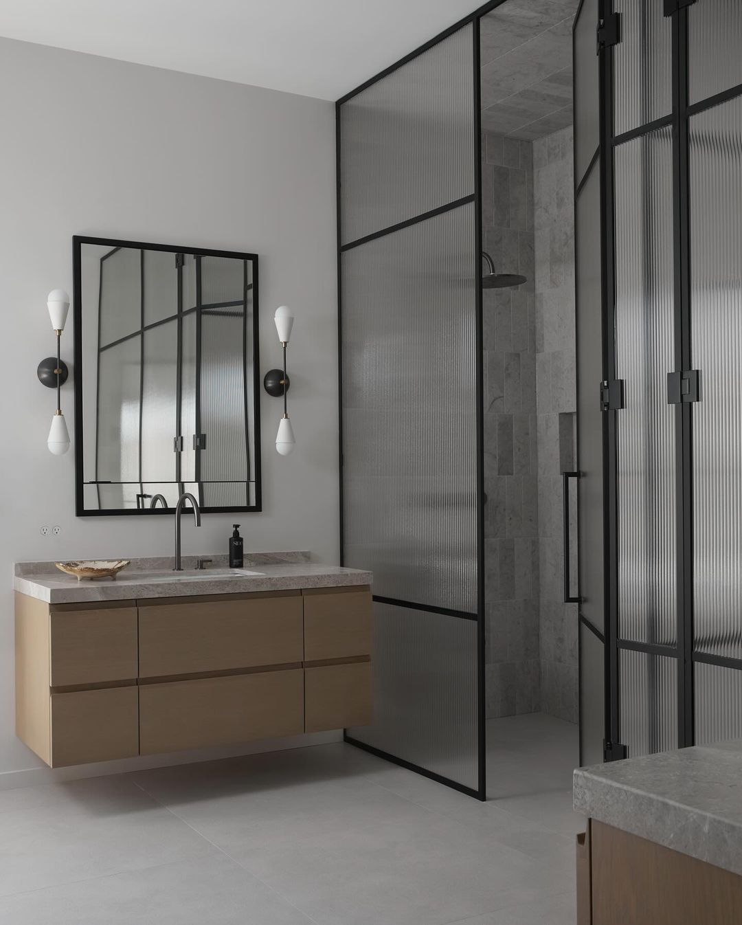 Gray tile and shower with wooden cabinet