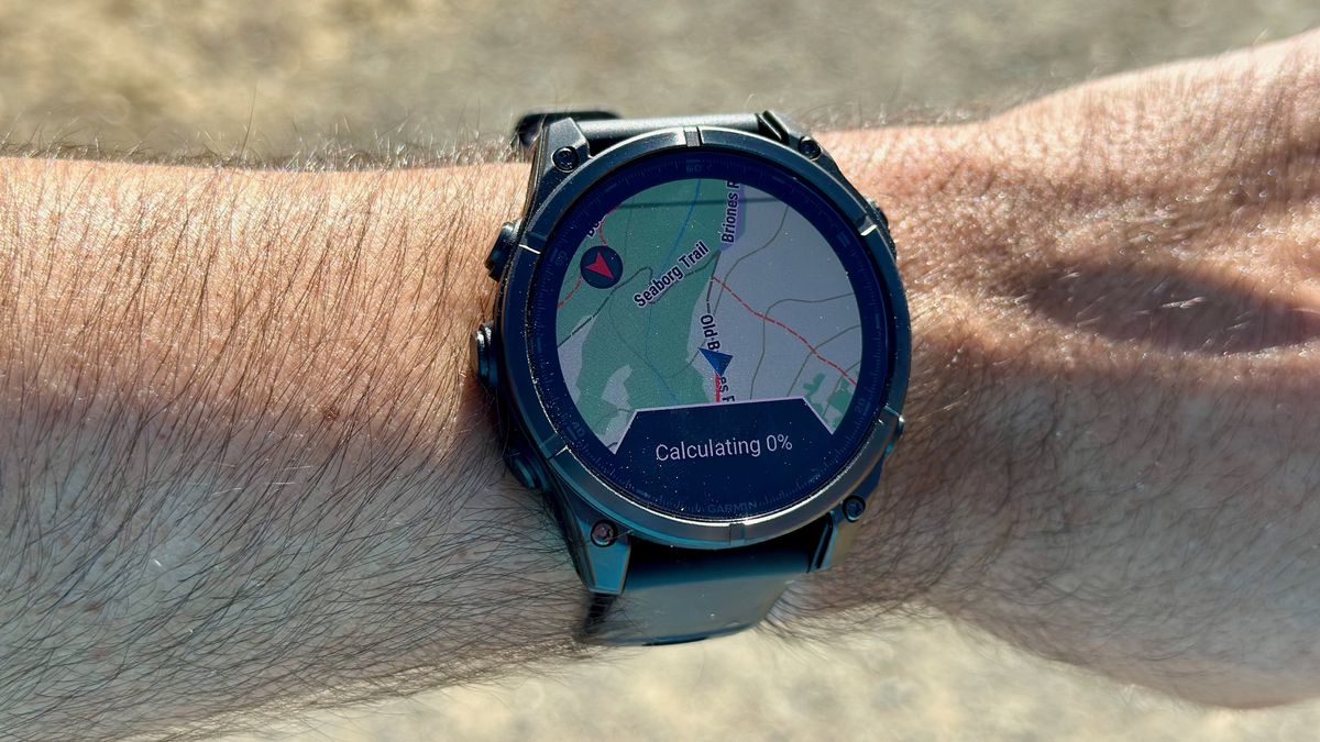 The Garmin Fenix 8 map view showing it "Calculating 0%" a round-trip route that never arrived
