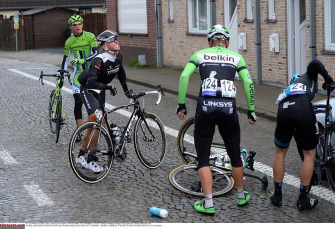 Riders pick themselves up after a crash in Dwars door Vlaanderen