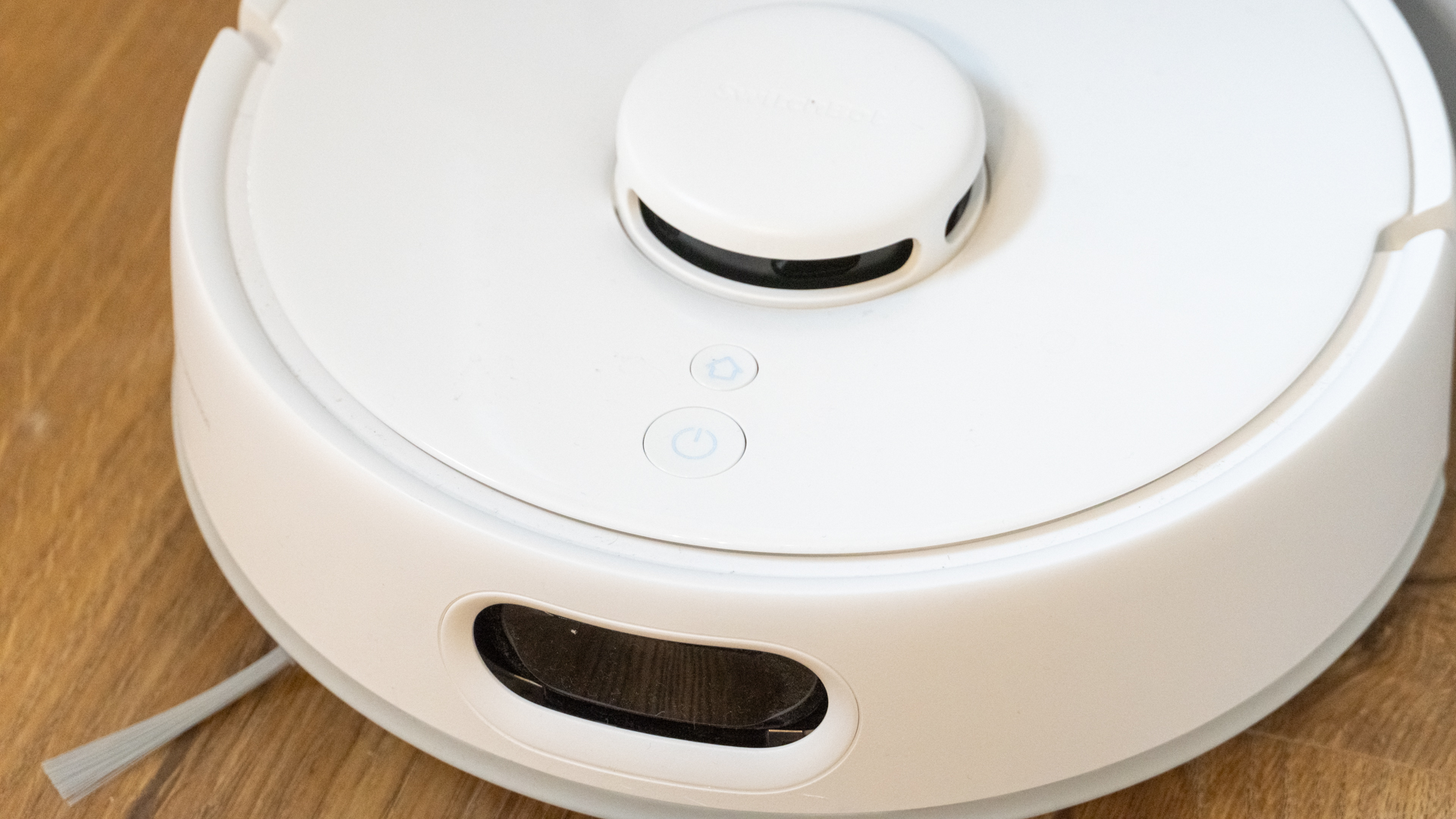 Close up of buttons and camera on SwitchBot K10+ Pro mini robot vacuum