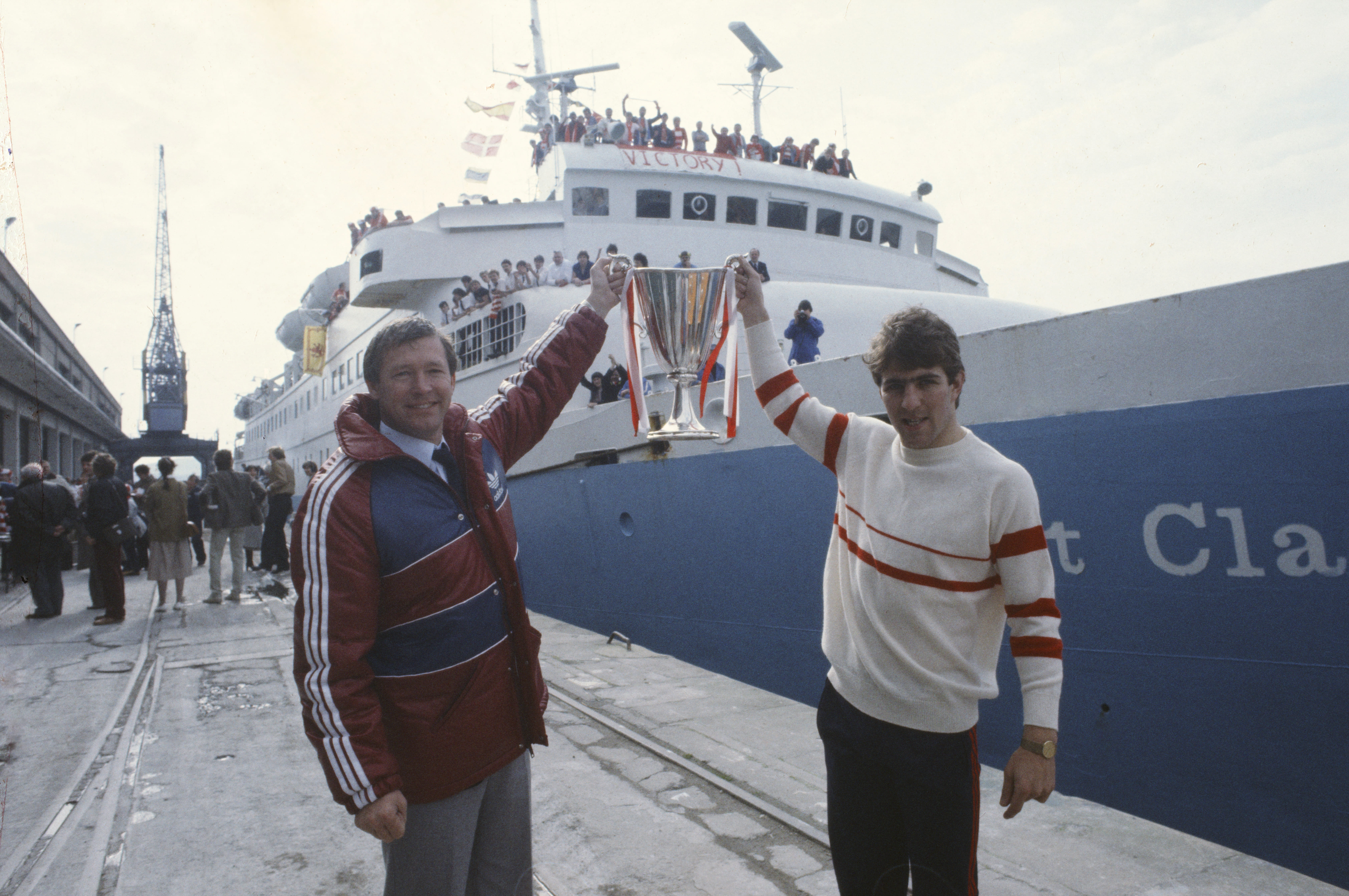 Alex Ferguson and Mark McGhee hold up the European Cup Winners' Cup as Aberdeen return home by boat following their victory over Real Madrid in the final in Gothenburg in May 1983.