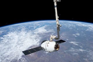 SpaceX Dragon Grappled By Robotic Arm 
