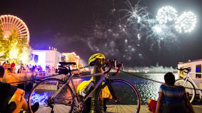 A cyclist watching fireworks
